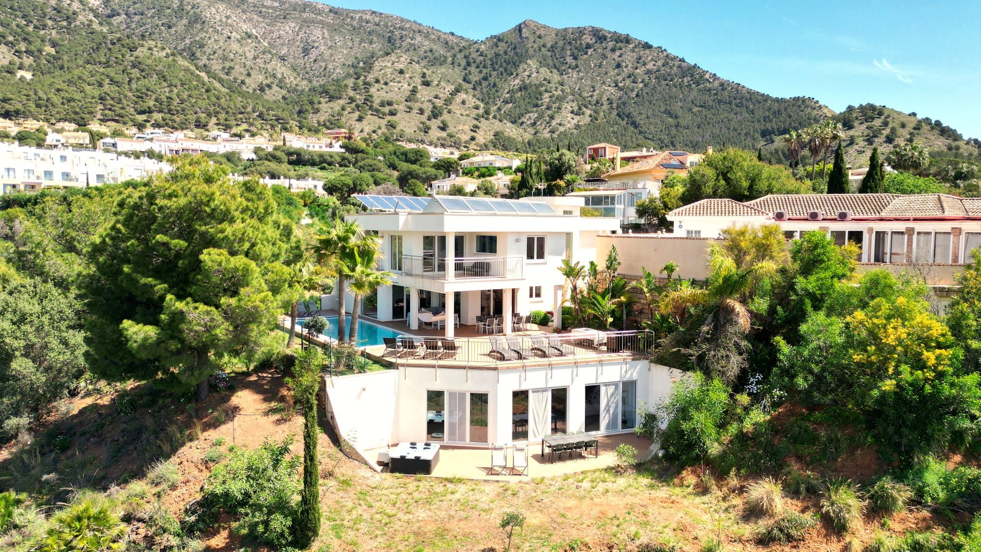 Aerial view of Villa Sol y Viento in its hillside setting